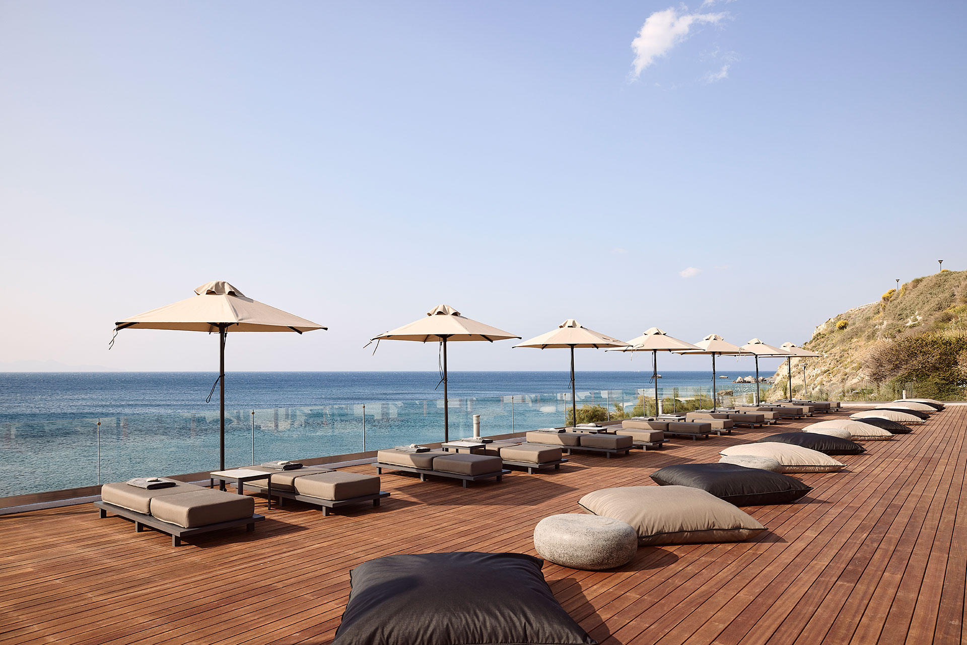 
Sunbeds and umbrellas and the sea as background