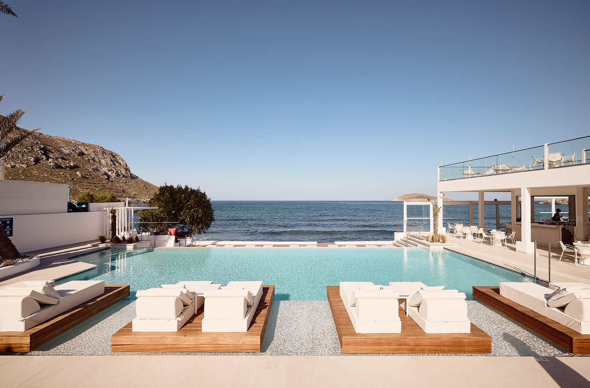 
Poolside and sunbeds with the sea as background