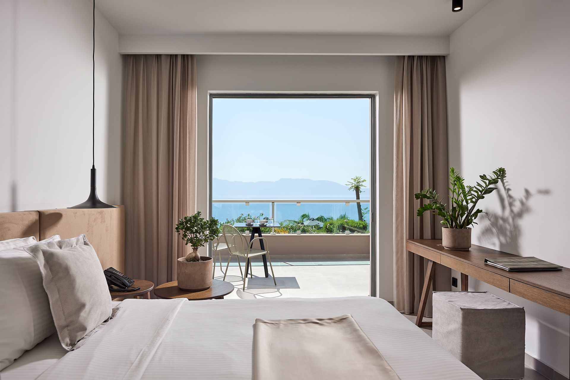 
View of the balcony and the sea from inside the room